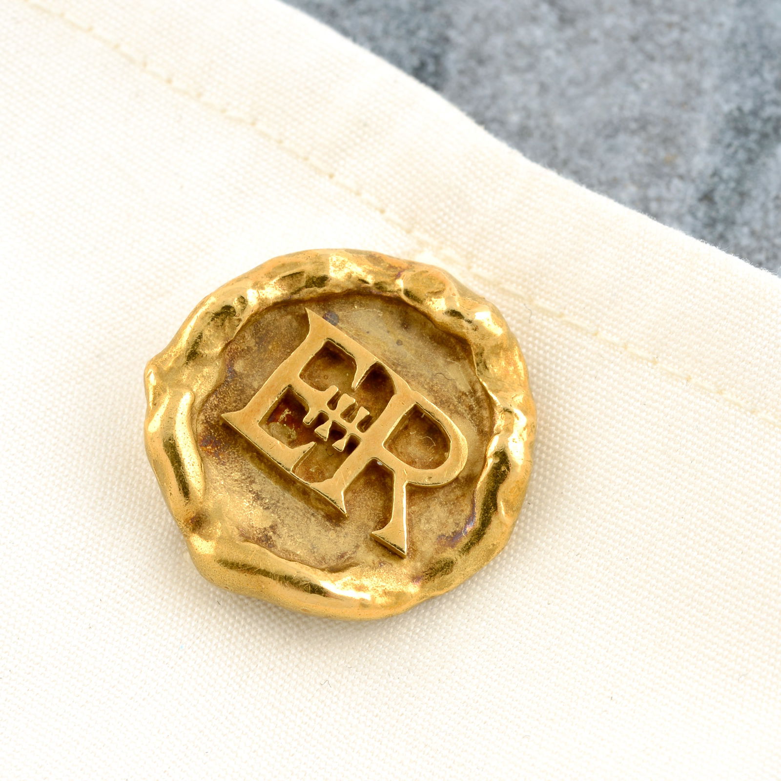Queen Elizabeth II monogram cufflinks, by Grima: A pair of 18ct gold Queen Elizabeth II monogram cufflinks, by Grima. Hallmarks for London, 1980. Diameter of cufflink face 1.9cms. 17.5gms. With maker's case.