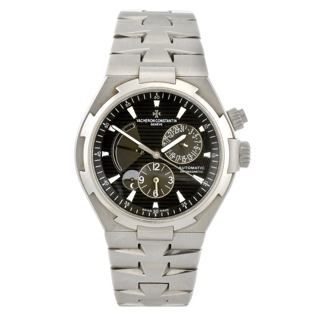 A stainless steel automatic gentleman's Vacheron C: VACHERON CONSTANTIN - a stainless steel automatic gentleman's Overseas Dual Time bracelet watch, the dark grey textured dial with luminous hourly applied markers, date subsidiary dial to three o'clock