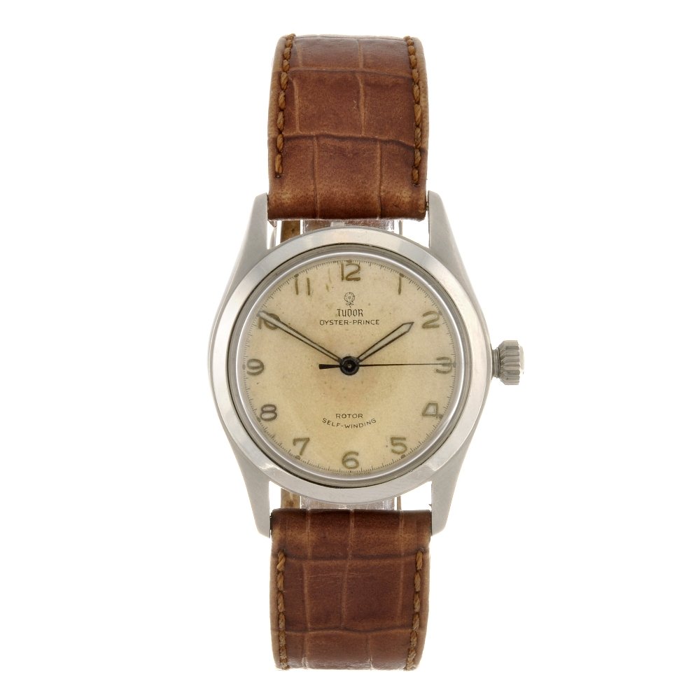 A stainless steel manual wind gentleman's Tudor Oy: TUDOR - a stainless steel automatic gentleman's Oyster Prince wrist watch, the silvered dial with hourly applied gilt Arabic numerals, bordered by a minute track, tonneau shaped case, fitted to a non-