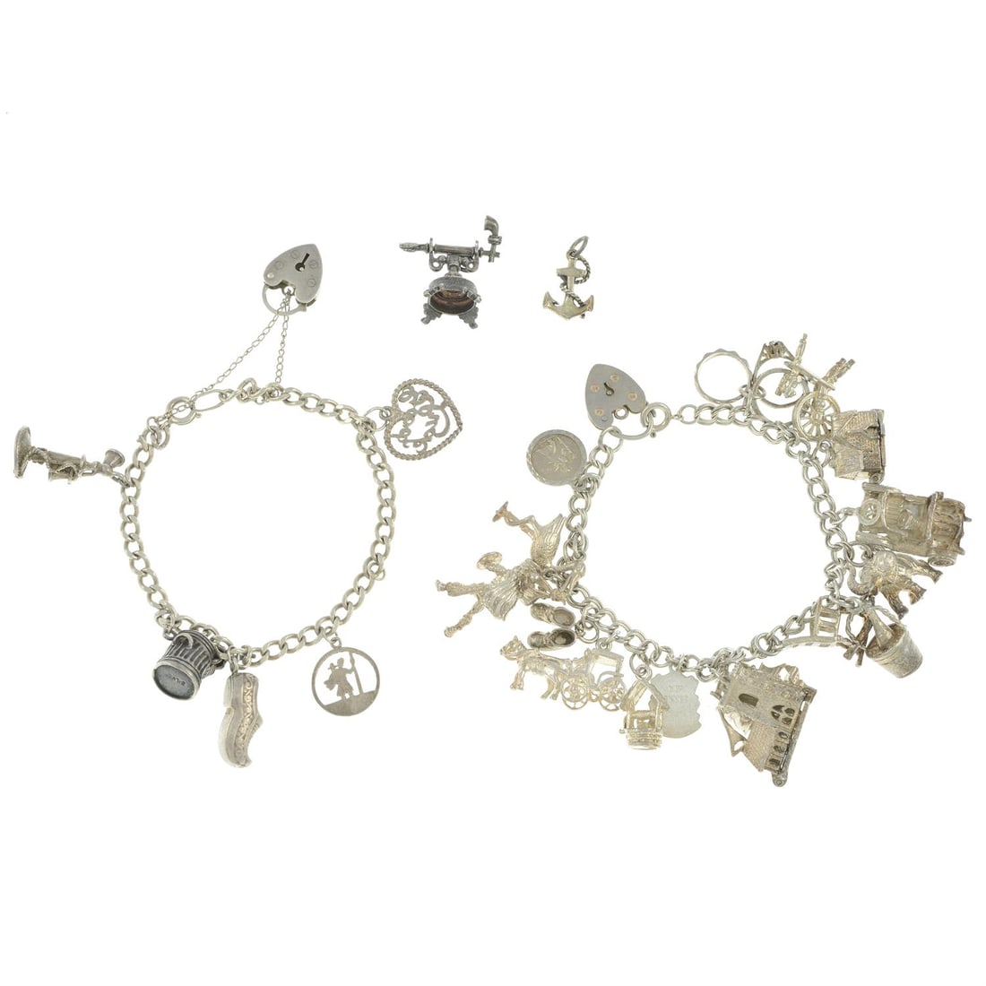 Two charm bracelets & two loose charms: A charm bracelet, suspending 16 charms to include a stork, an elephant and a wishing well, some with marks to indicate silver, length 18cms, 66gms. A charm bracelet, suspending five charms to include