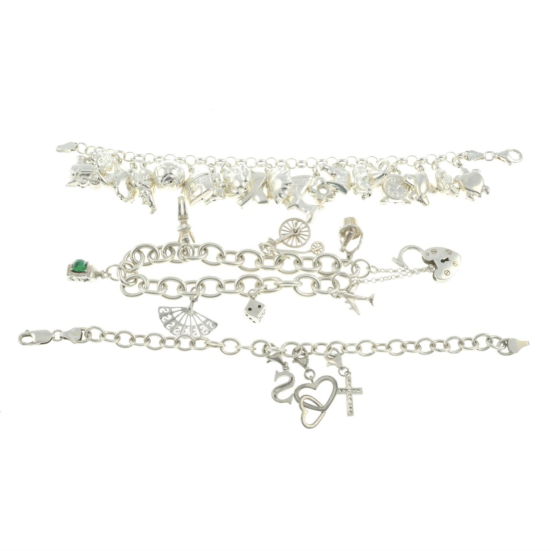 Three silver & white metal charm bracelets: Three silver and white metal charm bracelets. Two bracelets stamped 925. Lengths 18 to 19.5cm Total weight 84.4gm. Condition Report: Overall in good condition, with some surface scratches/ wear and mi