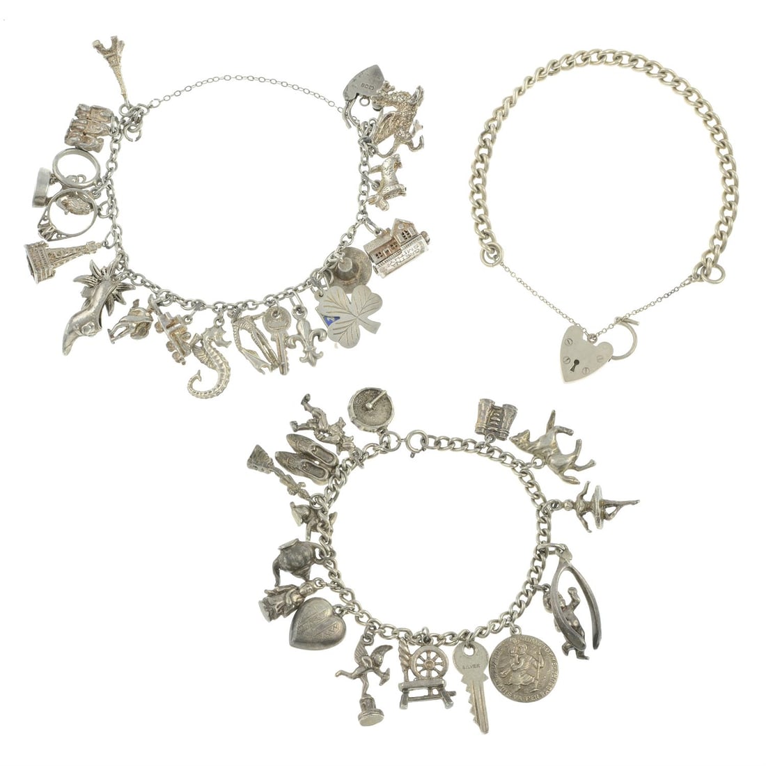 Two charm bracelets and a silver bracelet: A charm bracelet, suspending 19 charms to include the Eiffel tower, a matador and the three wise monkeys, some with marks to indicate silver, length 18cms, 48gms. A charm bracelet, suspending 17 charm