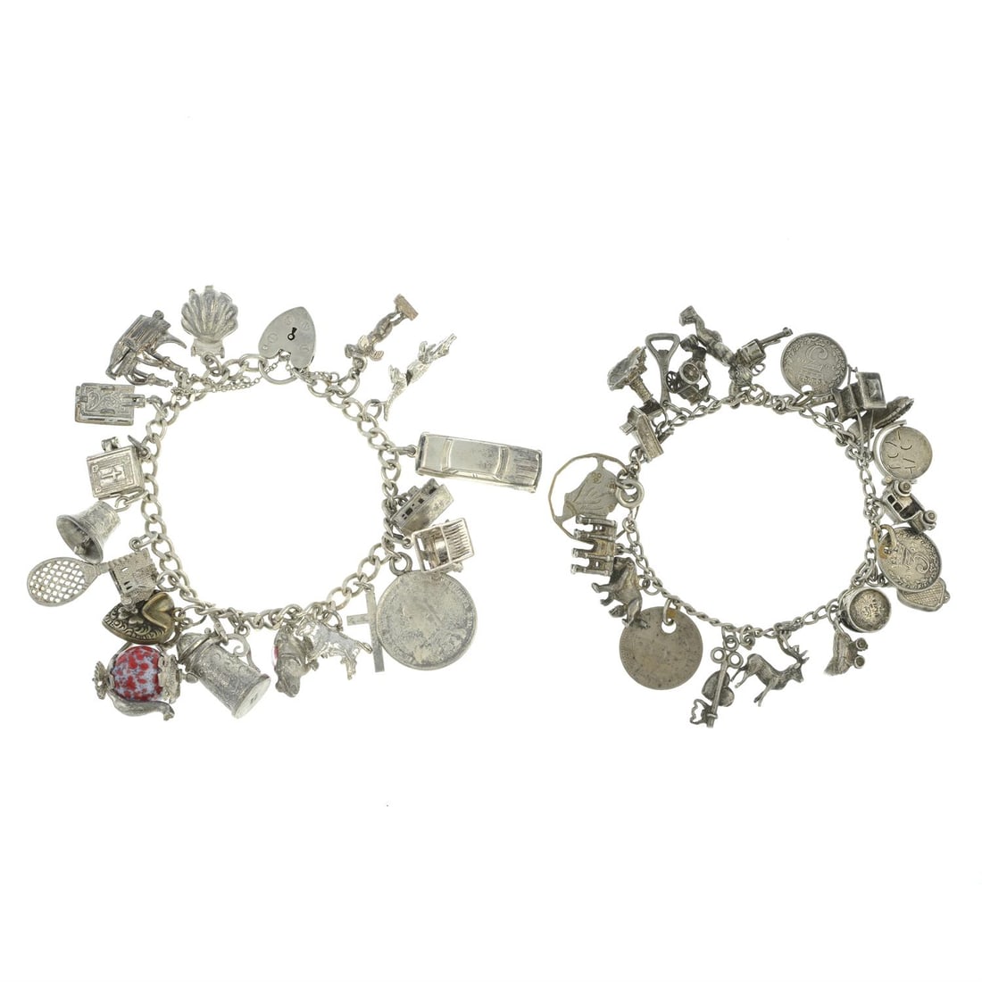Two charm bracelets: A charm bracelet, suspending 19 charms to include a bible, a typewriter and an articulated crocodile, some with marks to indicate silver, length 19cms, 71.2gms. A charm bracelet, suspending 22 charms