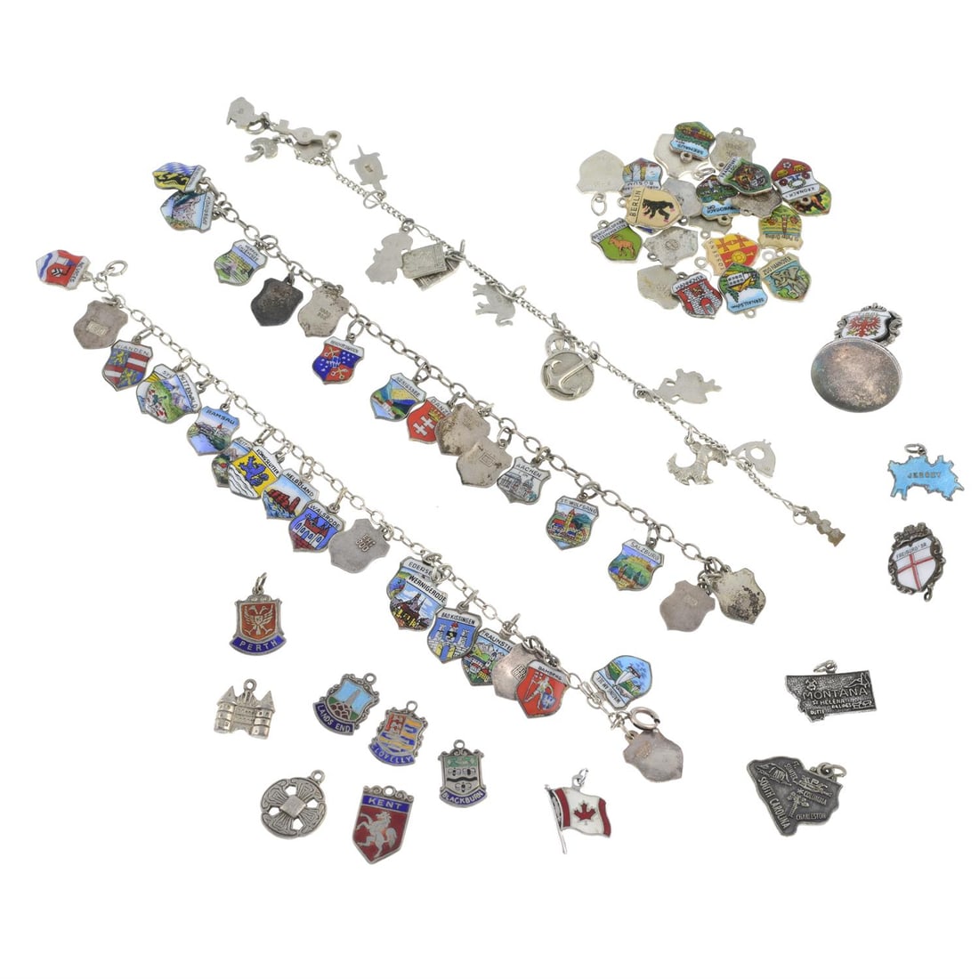 Three charm bracelets & loose charms: Three charm bracelets & loose charms Approximately Eighty-two charms in total. Approximately seven stamped sterling, four stamped 835, and thirty nine stamped 800. Total weight 101.4gm. Condition Repo