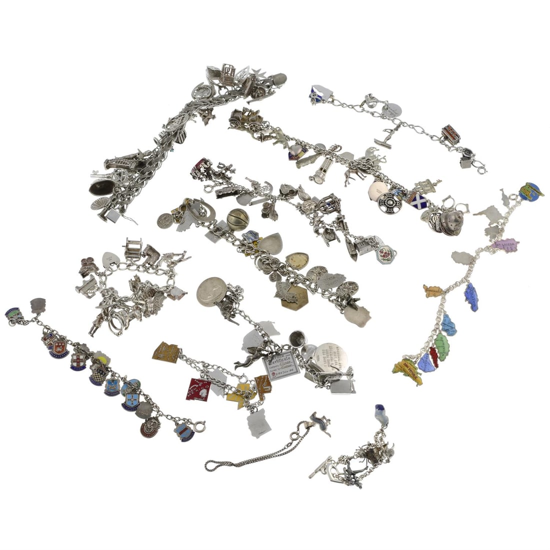 Twelve silver charm bracelets: Twelve silver charm bracelets, mostly with enamel.