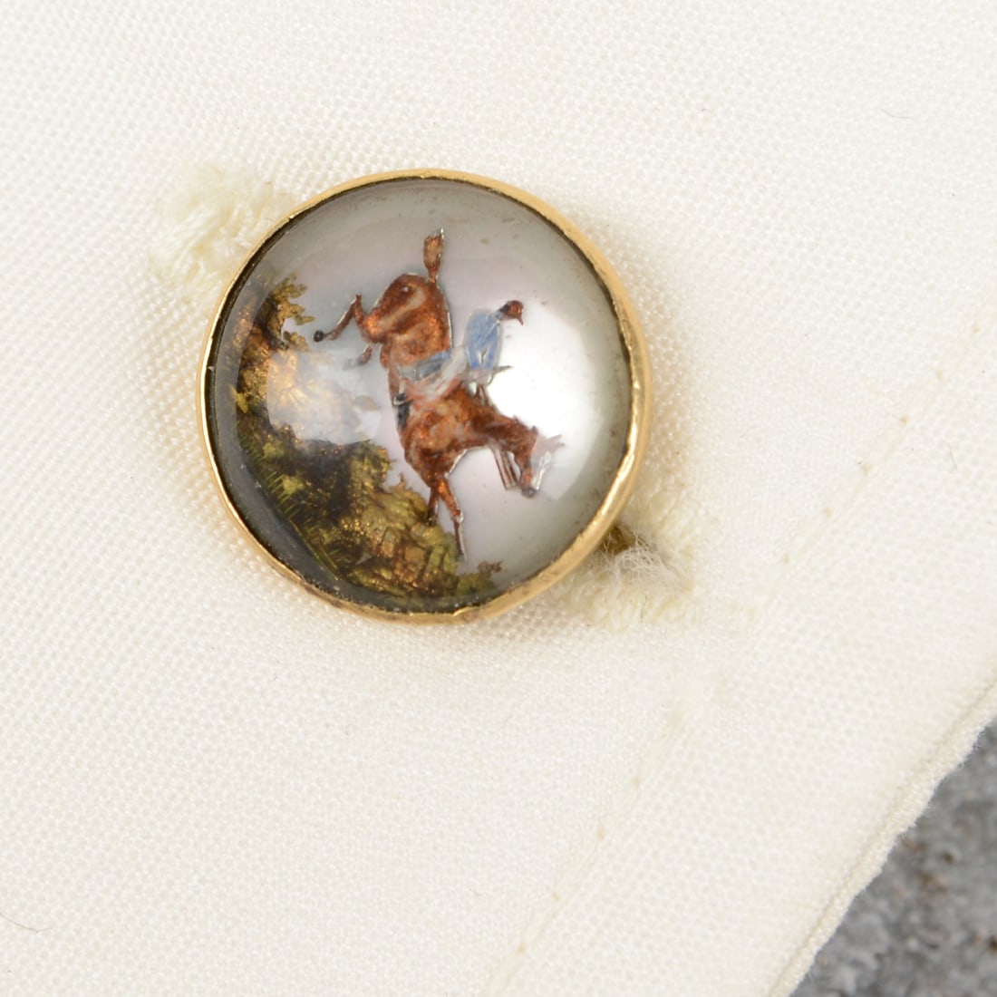 A pair of reverse-carved and painted rock crystal cufflinks, each depicting a jockey on racehorse (1 of 3)