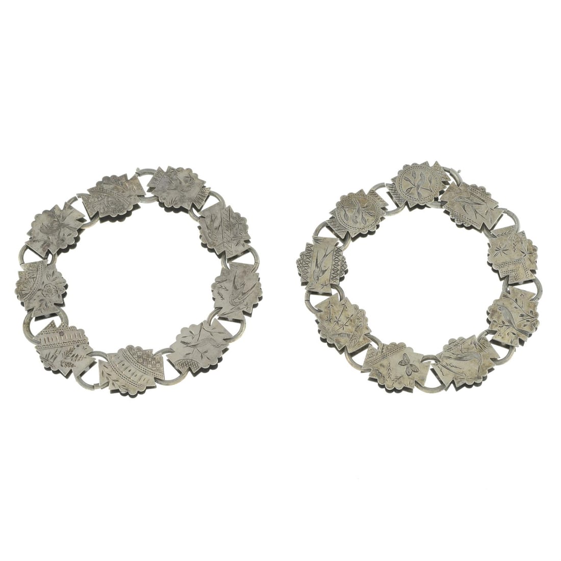 Two mid Victorian bracelets: Two similar mid Victorian silver fancy-link chain bracelets. Lengths 22cms each. 65.5gms. Condition Report: General marks, wear, discolouration and dents in keeping with general age and wear. Width at