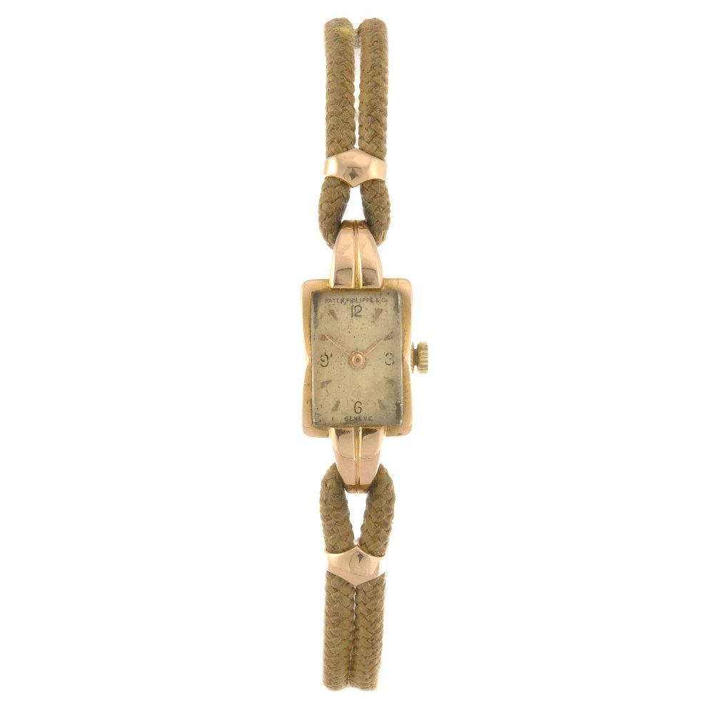 An 18k rose gold manual wind lady's Patek Philippe: PATEK PHILIPPE - an 18k rose gold manual wind lady's wrist watch, the silvered dial with arrow head hour markers, quarterly Arabic numerals, the rectangular shaped case, numbered 640208, stamped 0,750