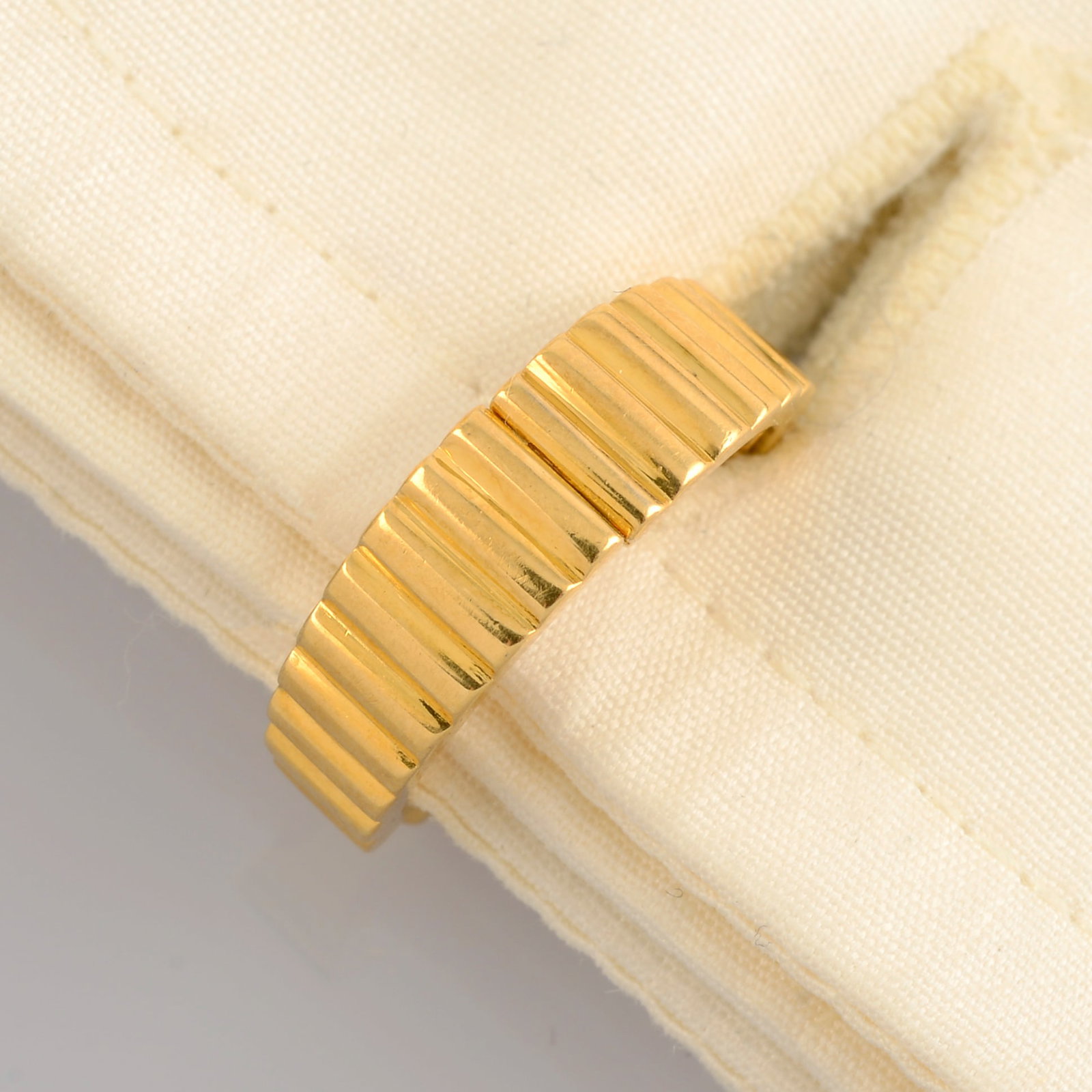 A pair of grooved cufflinks, by Van Cleef & Arpels. French assay marks. Length 1.8cms. 9gms. (1 of 4)