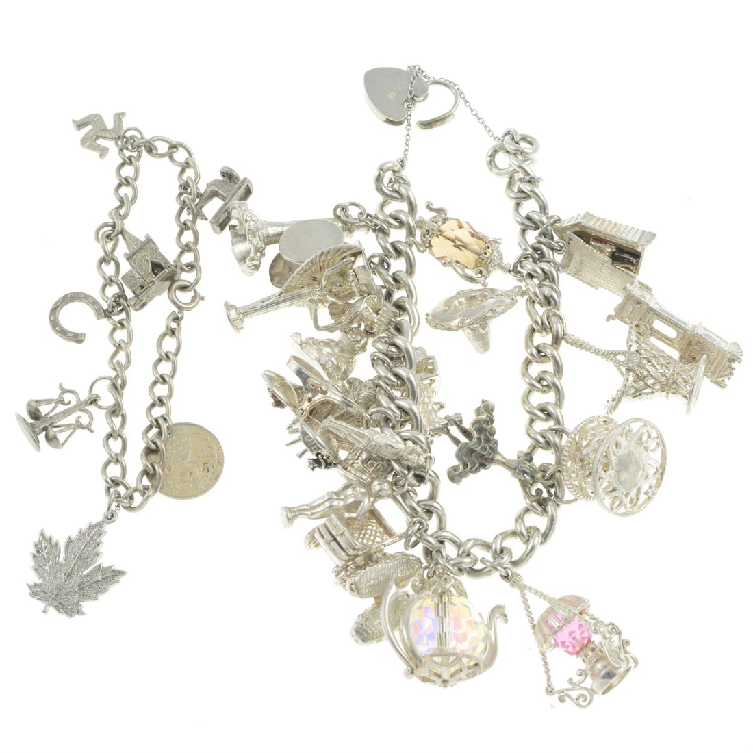 Two silver charm bracelets: A silver charm bracelet, bracelet stamped sterling, bracelet length 18cm, 137.3gm. A silver charm bracelet, bracelet stamped sterling, bracelet length 18.3cm, 19.7gm. Condition Report: Surface scratch