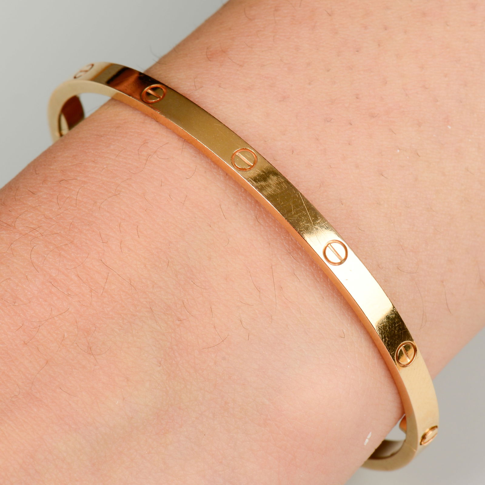 An 18ct gold 'Love' bangle, by Cartier. Swiss convention marks. Inner diameter 5.5cms. Cartier size (1 of 6)