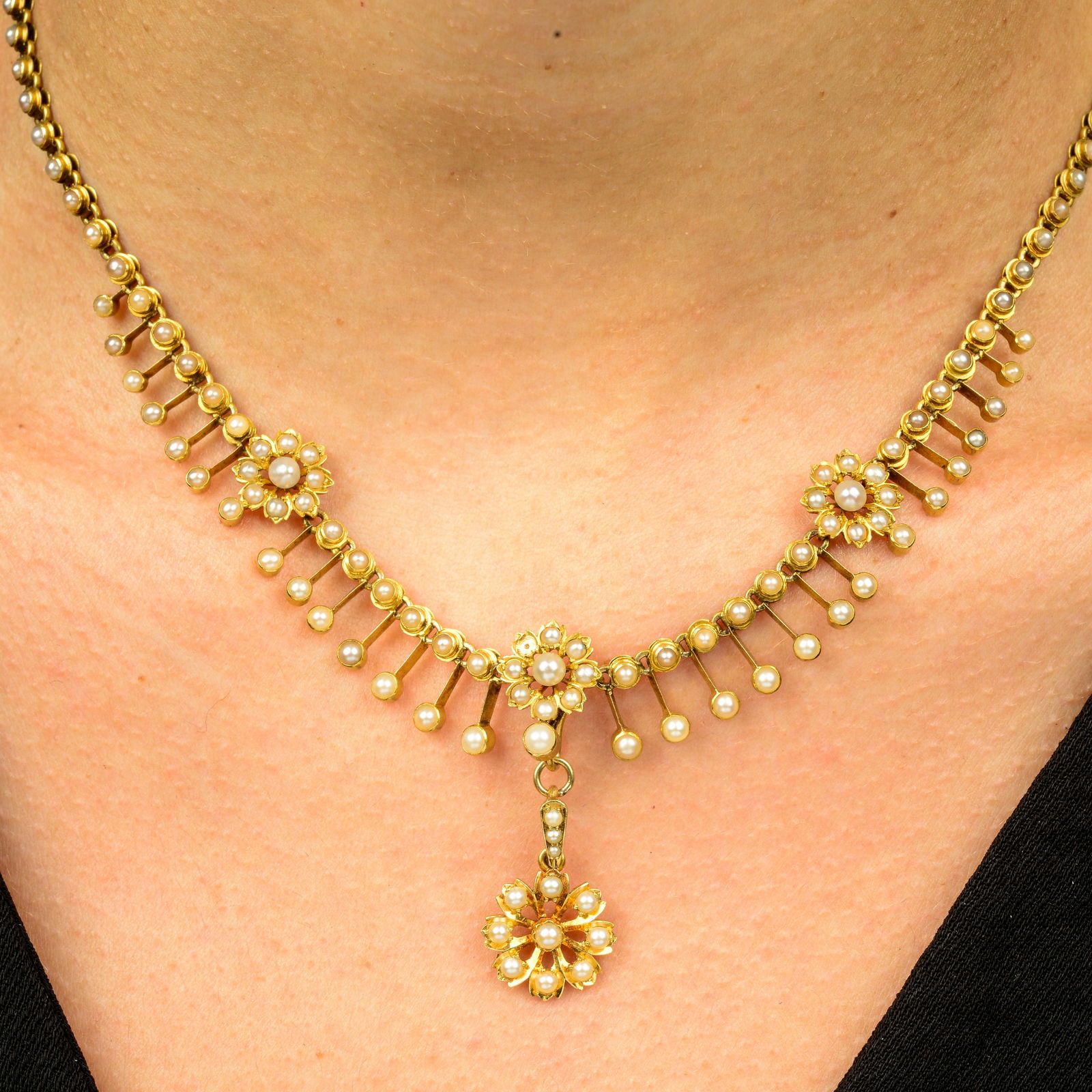 A late Victorian gold split and seed pearl floral fringe necklace, with similarly-designed (1 of 6)
