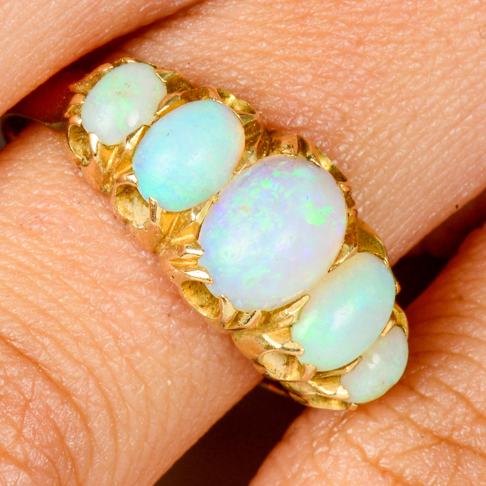 An early 20th century 18ct gold graduated opal five-stone ring.Central opal calculated weight (1 of 6)