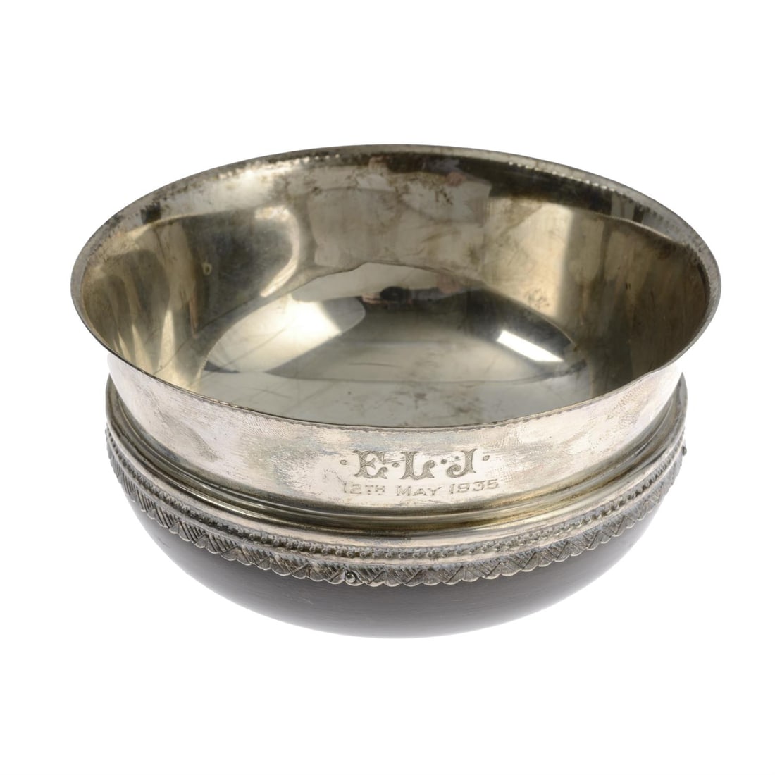1930's silver mounted wood bowl.: A 1930's Mazer bowl with turned wooden base and silver edge and bowl. Hallmarked Thomas Bradbury & Son, Sheffield 1933. Diameter 12cm, gross weight 7ozt (220g). Condition Report: Personal engraving E.