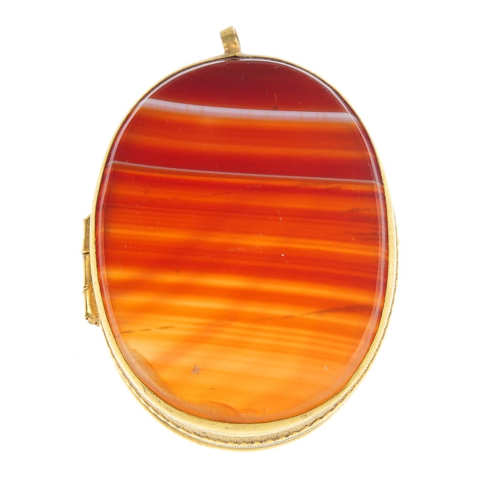 An agate locket.: An agate locket, of oval-shape outline, the banded orange agate panels to the textured sides. Length 3.7cms.