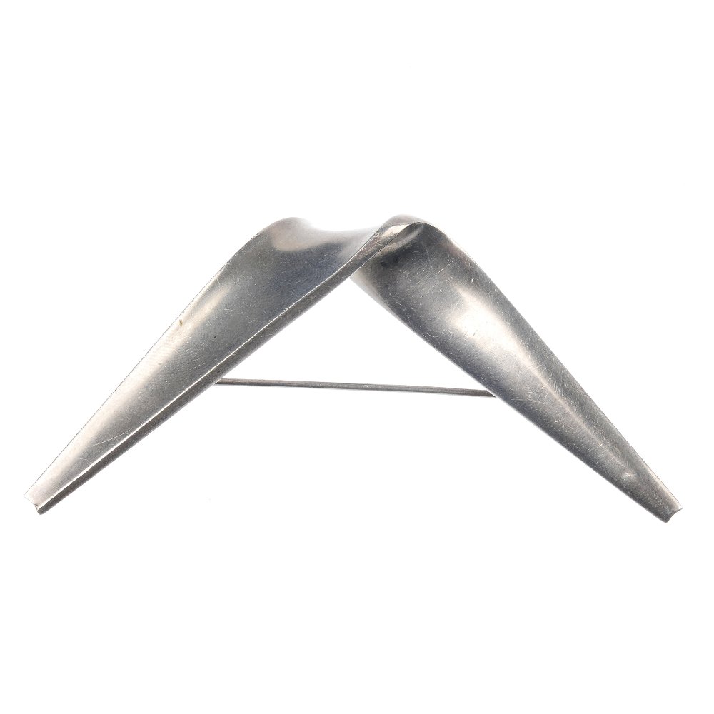 ANTON MICHELSON - a 1960s Danish silver modernist: ANTON MICHELSON - a 1960s Danish silver Modernist brooch by Eigil Jensen for Anton Michelson, designed as a curved, tapering panel. With Anton Michelson maker's mark. EJ monogram. Import marks for Lon