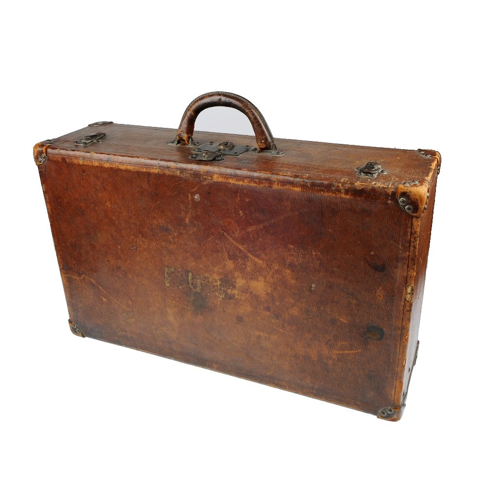 LOUIS VUITTON- an antique suitcase.: LOUIS VUITTON - an early 20th century suitcase, the brown case with initials to the top, studded leather corner caps, cotton lining and inner straps. Heavily worn. Clasp stamped Paris Louis Vuitton Lo