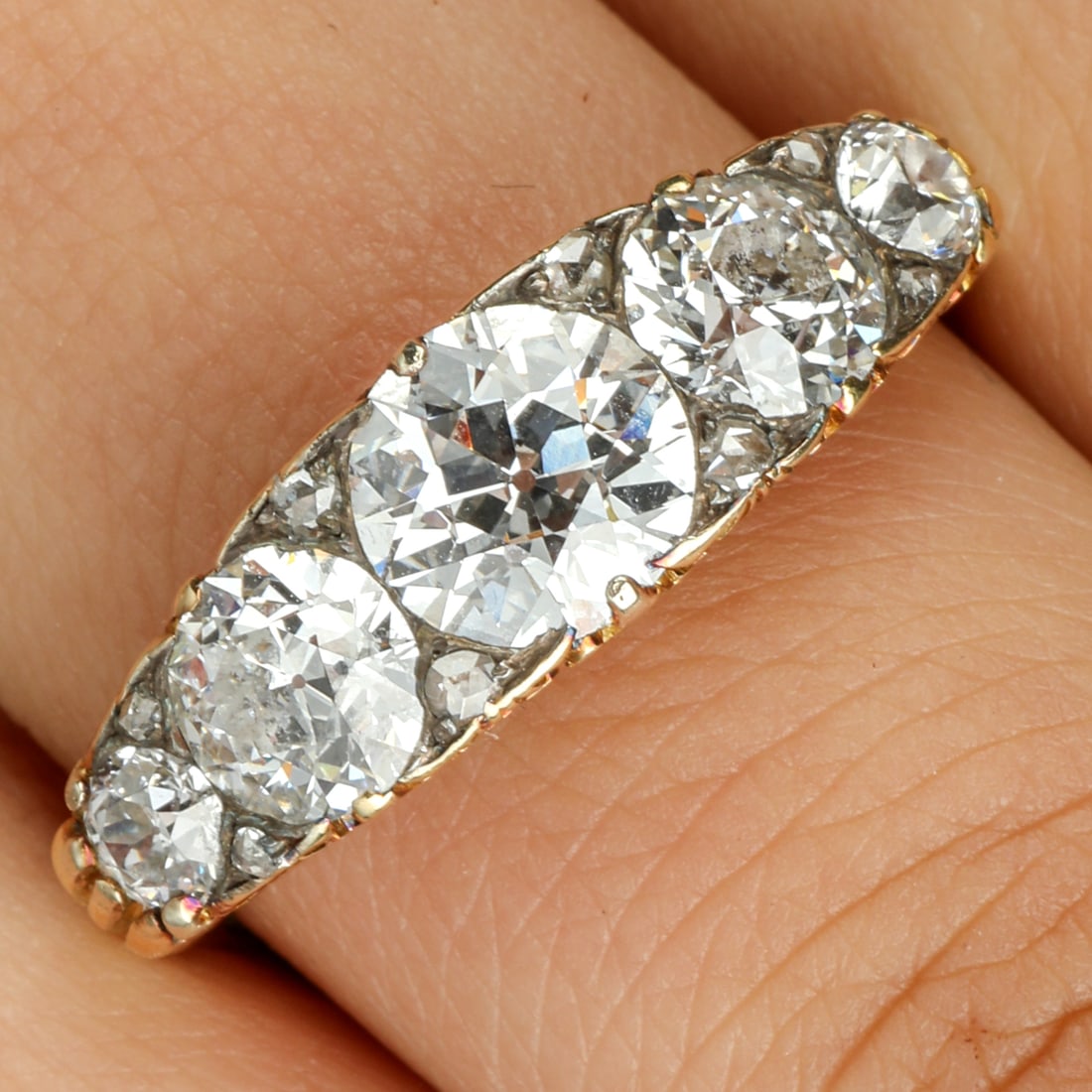 Late Victorian 18ct gold diamond five-stone ring: A late Victorian 18ct gold graduated circular-cut diamond five-stone ring, with diamond point spacers. Estimated total diamond weight 2.70cts, G-J colour, SI1-P1 clarity. Stamp indistinct. Ring size R