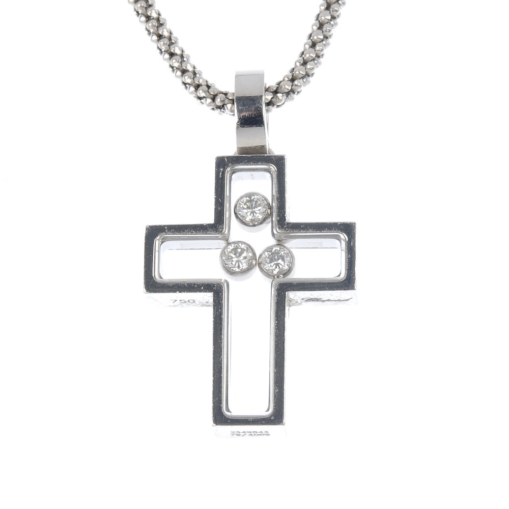 CHOPARD - a 'Happy Diamond' cross pendant.: CHOPARD - a 'Happy Diamond' cross pendant. The centre designed as three brilliant-cut diamond free moving collets, within a cross-shape surround, suspended from an 18ct gold fancy-link chain. Signed C