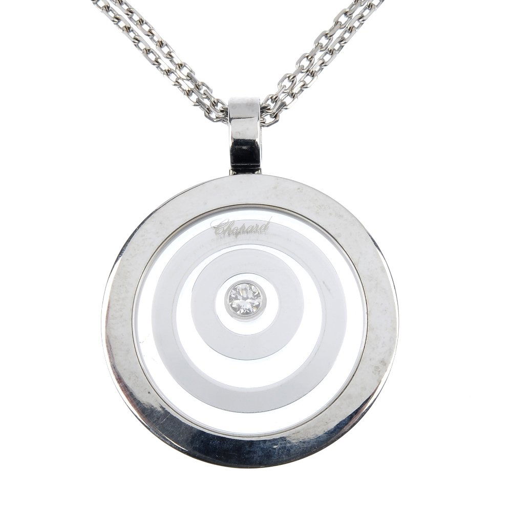 CHOPARD - an 18ct gold 'Happy Spirit' diamond pend: CHOPARD - an 18ct gold 'Happy Spirit' diamond pendant. Designed as a free-moving brilliant-cut diamond collet, within a concentric circle surround, suspended from a double fancy-link chain. Signed Cho