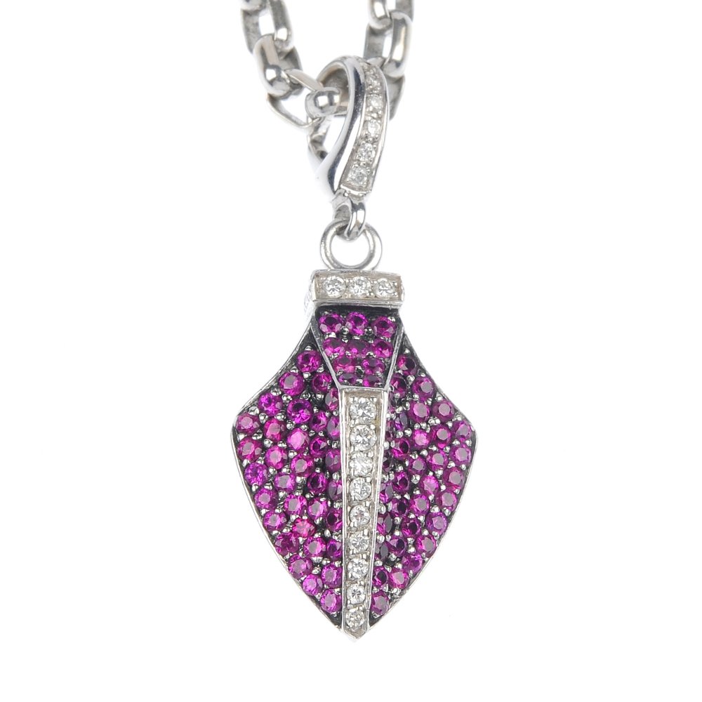 THEO FENNELL - an 18ct gold ruby and diamond 'Quiv: THEO FENNELL - an 18ct gold ruby and diamond 'Quiver' pendant. Of stylised arrowhead design, the pave-set ruby panels, with brilliant-cut diamond line detail and surmount, suspended from a trace-link 
