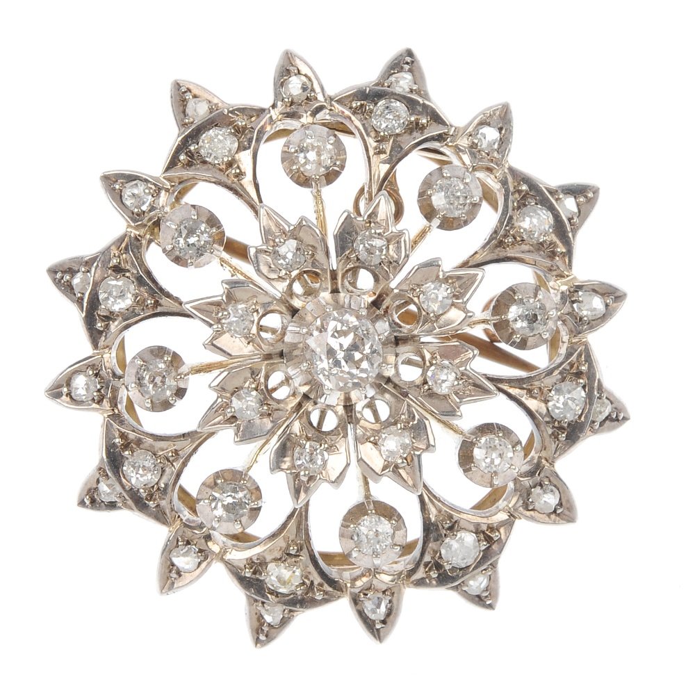 A late 19th century 15ct gold and silver diamond b: A late 19th century 15ct gold and silver diamond floral brooch. Of openwork design, the old-cut diamond, within a similarly-cut diamond floral surround. Estimated total diamond weight 1.40cts, H-J col