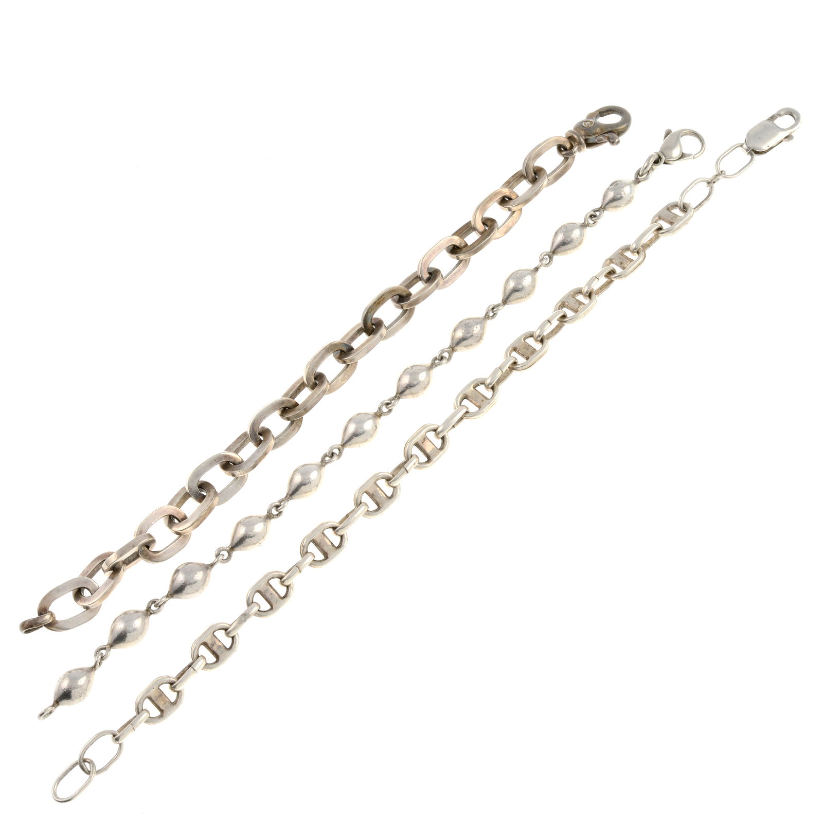 Three fancy-link bracelets.: Three fancy-link bracelets. One with import marks for Birmingham, partially indistinct, one stamped 925, one stamped 925 to clasp. Lengths from 17 to 21.5cms. 63.5gms. Due to the amount of items in th