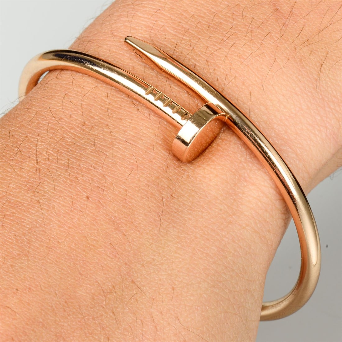 'Juste un Clou' bangle, by Cartier: A 'Juste un Clou' bangle, by Cartier. Stamped Au750. Inner diameter 6cms. Cartier size 17. 32.4gms. Condition Report: Surface scratches and minor marks.Recently polished.Signed Cartier, OFM810. Free v