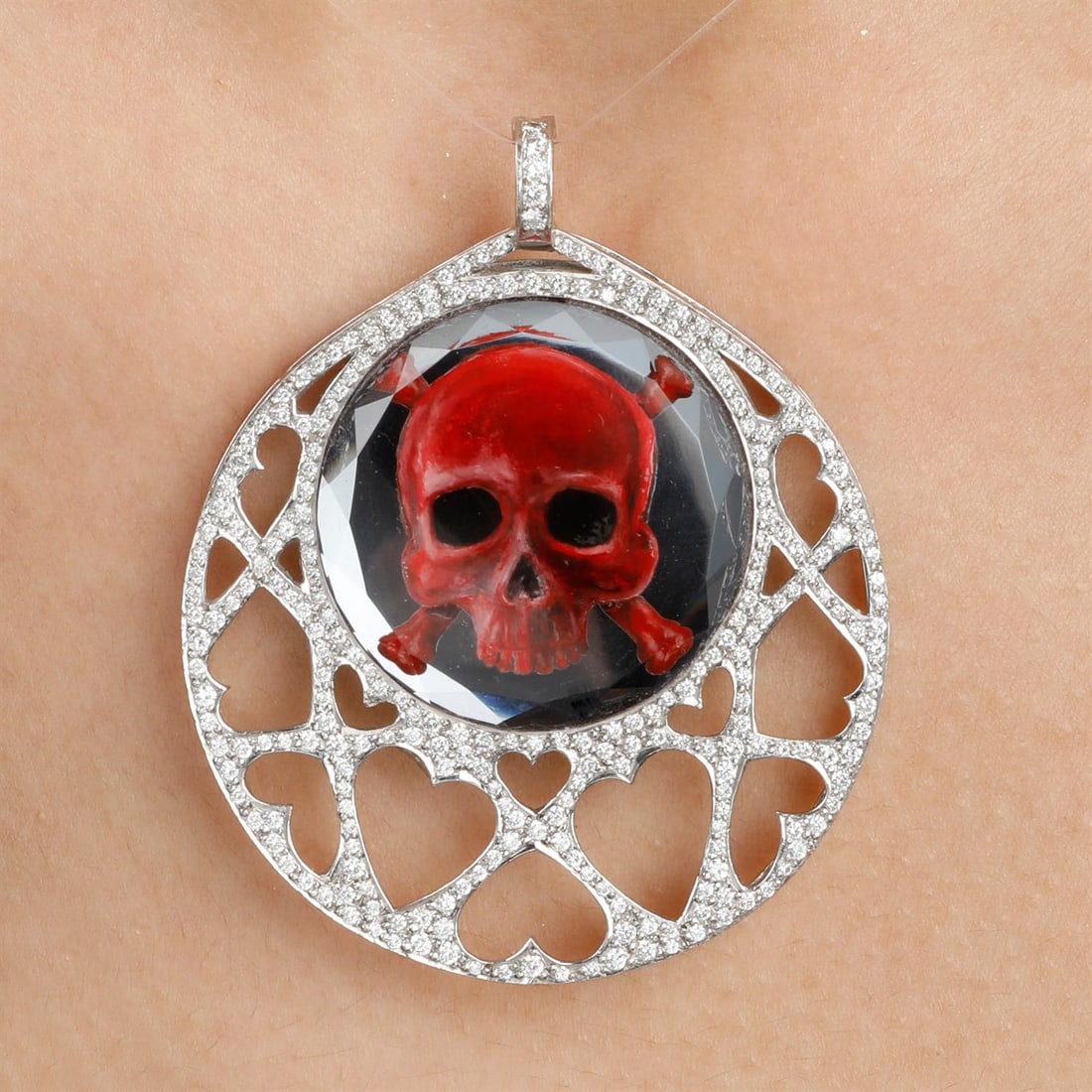 Diamond skull pendant, by Stephen Webster: A modified red skull motif diamond pendant, by Stephen Webster. Estimated total diamond weight 0.85ct.Stamped 750. Length 6cms. 34gms. Condition Report: Scratches and small marks.Replacement/altered s