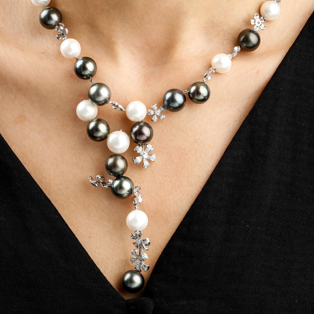 Cultured pearl and diamond necklace and earrings: A grey and white cultured pearl and diamond floral necklace, with matching earrings. Cultured pearl estimated diameter 11.3 to 13.2mms. Estimated total diamond weight 2.70cts. Stamped 750. Wearable le