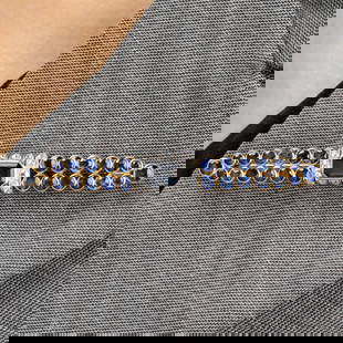'Barrette' brooch, by Suzanne Belperron: A mid 20th century platinum and gold sapphire and old-cut diamond 'Barrette' brooch, by Suzanne Belperron. With Certificate of Origin from Olivier Baroin stating that the brooch was manufactured by Gr
