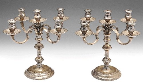 Pair of modern silver four branch candelabra.: Modern silver pair of small four branch candelabra in early eighteenth century style, each with spreading circular base rising to a knopped central column, the upper detachable section with central ci