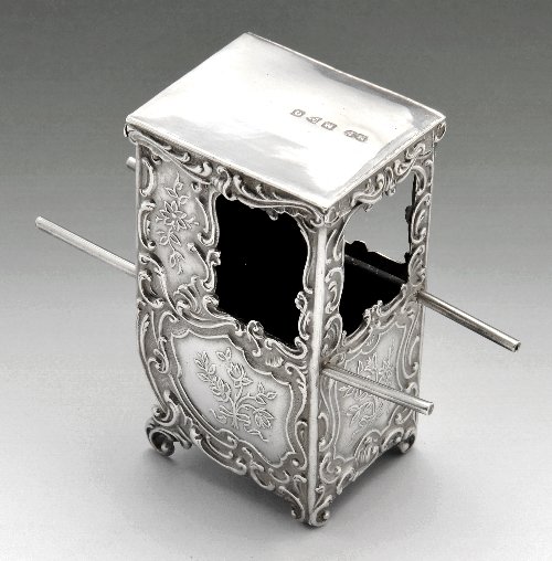 A late Victorian miniature/toy silver litter.: A late Victorian miniature/toy silver litter with scroll and floral decoration. Hallmarked Maurice Freeman London/Chester 1899. Height measuring 6 cm, weight 32 grams.