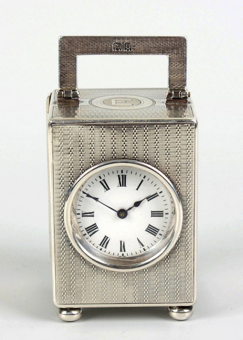 A silver miniature carriage clock by Mappin & Webb: A silver miniature carriage clock by Mappin & Webb. Having a 1.25" white Roman dial, the back-wound timepiece movement with lever platform escapement, stamped "FRENCH MOVEMENT" and with lion stamp for