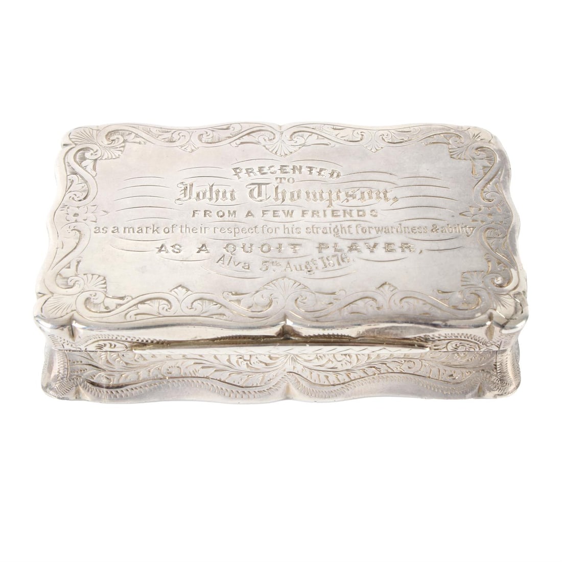 Victorian silver snuff box.: A Victorian silver snuff box, of scroll-edge rectangular form, with foliate engraved base, sides and border enclosing personal engraving to lid reading, 'Presented to John Thompson, from a few friends