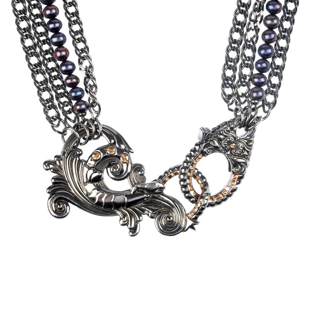 STEPHEN WEBSTER - a silver and cultured pearl neck: * STEPHEN WEBSTER - a silver and cultured pearl necklace. The silver scrolling clasp, with embossed lobster detail, suspending three double-curb link chains and a single-strand of eighty-five black cu