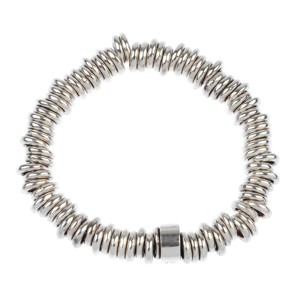 A selection of jewellery.: * A selection of jewellery. To include two silver spherical bead necklaces of similar design, each with T-bar clasp and two elasticated circular-link bracelets of similar design. Necklaces with hallma