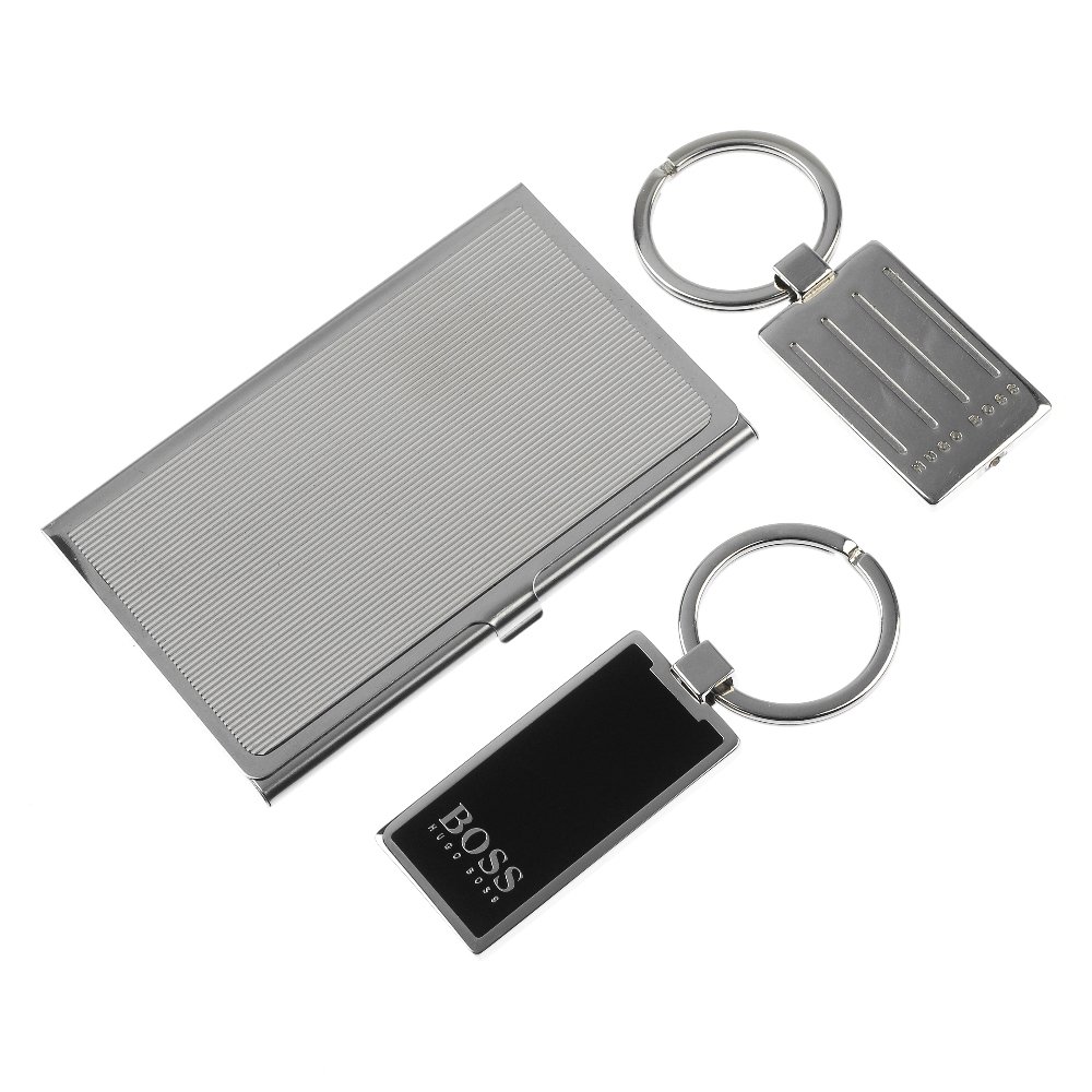A group of five gentleman's giftwear.: * A group of five gentleman's giftwear items. To include a Hugo Boss wallet, a silver plated business card holder and three Hugo Boss key rings.
