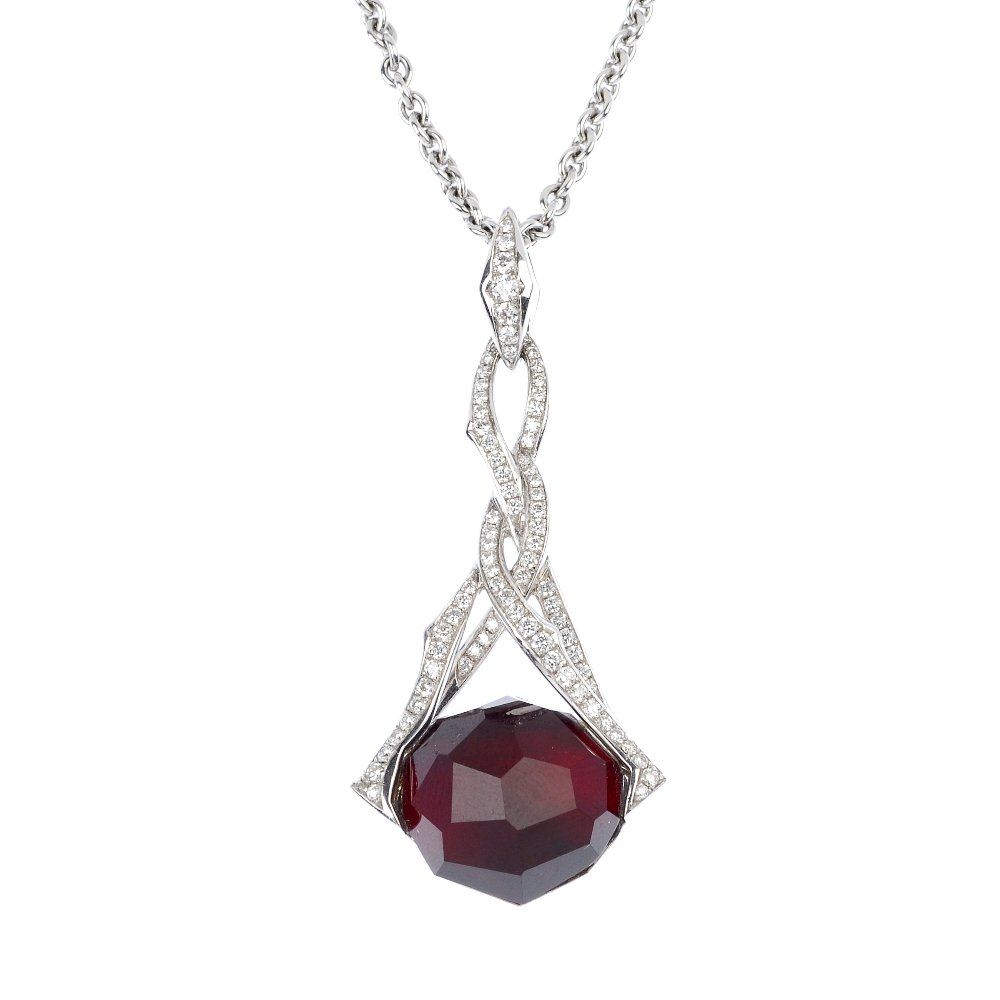 STEPHEN WEBSTER - an 18ct gold 'Crystal Haze' garn: * STEPHEN WEBSTER - an 18ct gold garnet, quartz and diamond 'Crystal Haze' pendant. The oval-shape garnet, with a faceted quartz top, to the entwined pave-set diamond surmount, suspended from a belche