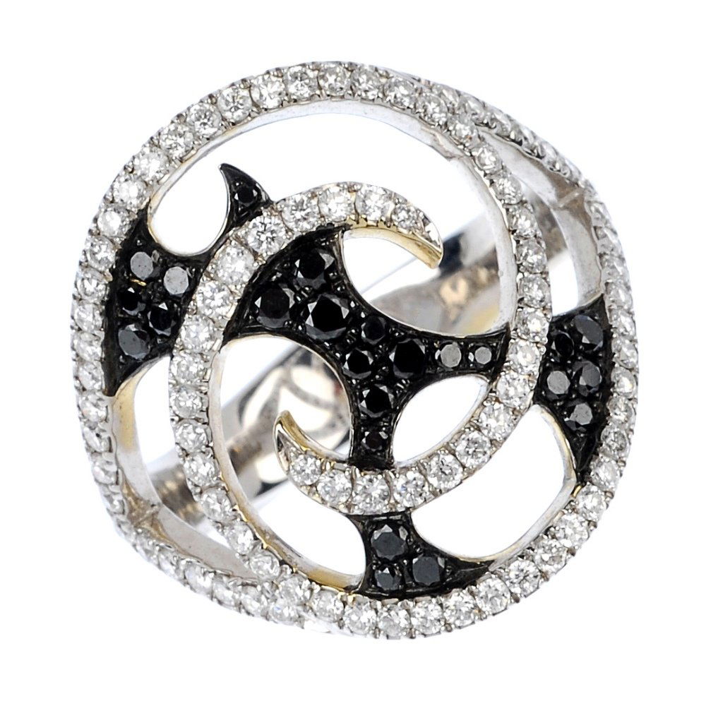 STEPHEN WEBSTER - an 18ct gold 'Fly By Night Vorte: * STEPHEN WEBSTER - an 18ct gold diamond and colour treated diamond 'Fly By Night Vortex' ring. Of openwork design, the brilliant-cut diamond swirl, with circular-shape colour treated black diamond ab