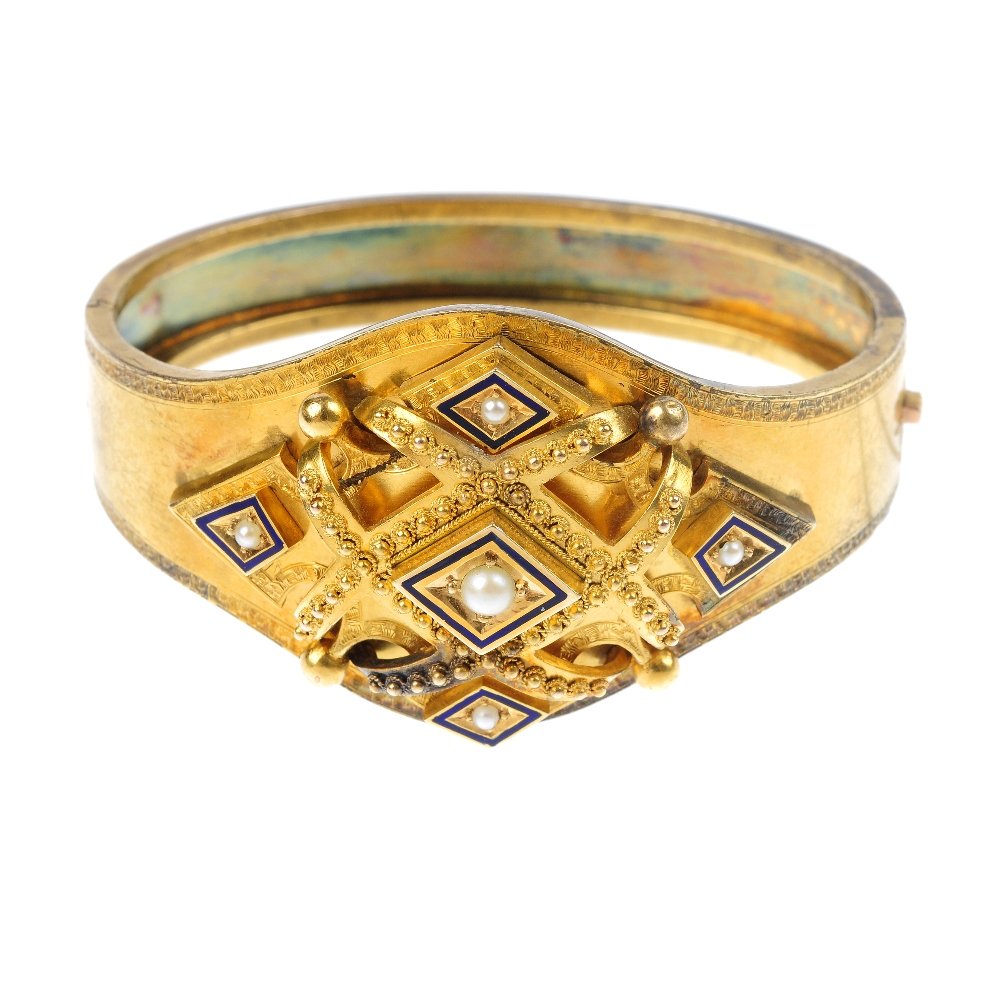 A mid Victorian split pearl and enamel hinged bang: A mid Victorian 18ct gold split pearl and enamel hinged bangle, circa 1850. The front designed as a series of seed pearl and lozenge-shape blue enamel panels, within a canetille lattice-work surround,