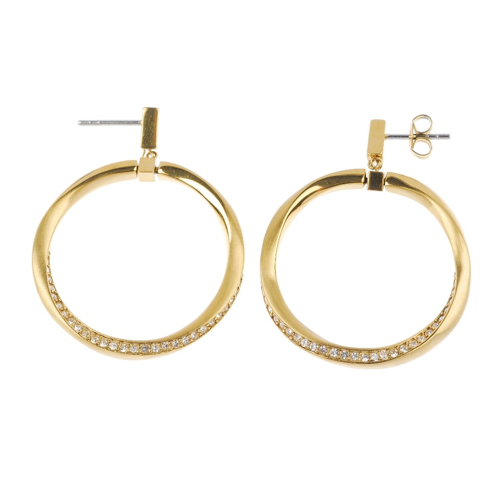 A collection of jewellery.: * A collection of jewellery. To include a pair of DKNY cubic zirconia ear hoops, a purple cubic zirconia single-stone ring, a heart-shape charm bracelet, together with three further items. The first s