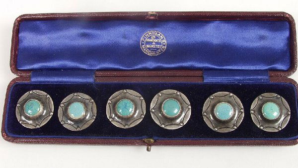 An Edwardian set of six circular silver: An Edwardian set of six circular silver buttons, with central circular turquoise enamelled panel, each 3cm diameter, by A.E. Jones, Birmingham, 1903, with fitted case.