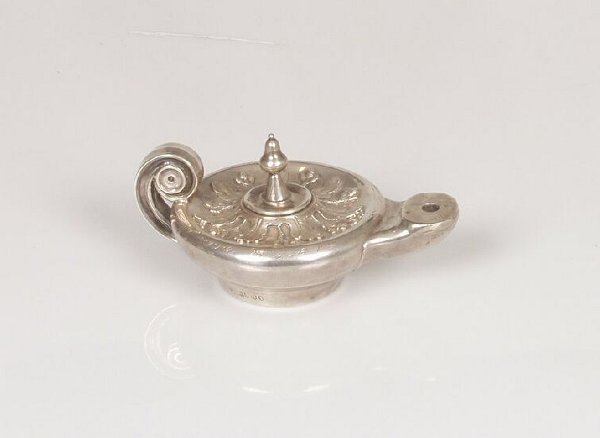 A Victorian novelty table lighter model: A Victorian novelty table lighter modelled as Aladdin's lamp, with cut card work acorns and oak leaves, scroll handle and engraved presentation inscription, maker George Fox, London 1883, 5.5" (14cm)