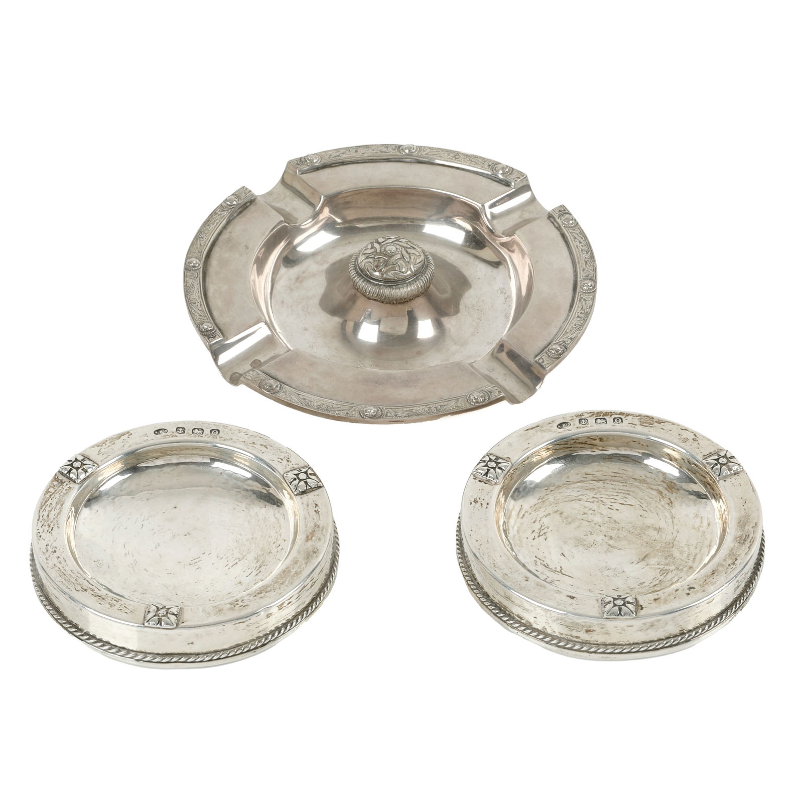 Pair of A.E. Jones dishes; plus Celtic ashtray (3): Pair of A.E. Jones dishes; plus Celtic ashtray (3) A pair of silver pin dishes of circular form with square flower head motif and a rope twist border, hallmarked A.E Jones, Birmingham 1913 or 1938, di