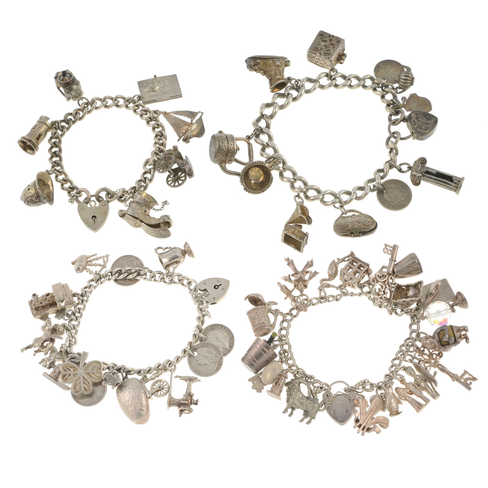 Four silver charm bracelets: Four silver charm bracelets Several with hallmarks. Many with marks to indicate silver. Charms to include agate heart padlock, key, bagpipes, penguin and boat amongst many others. Length of