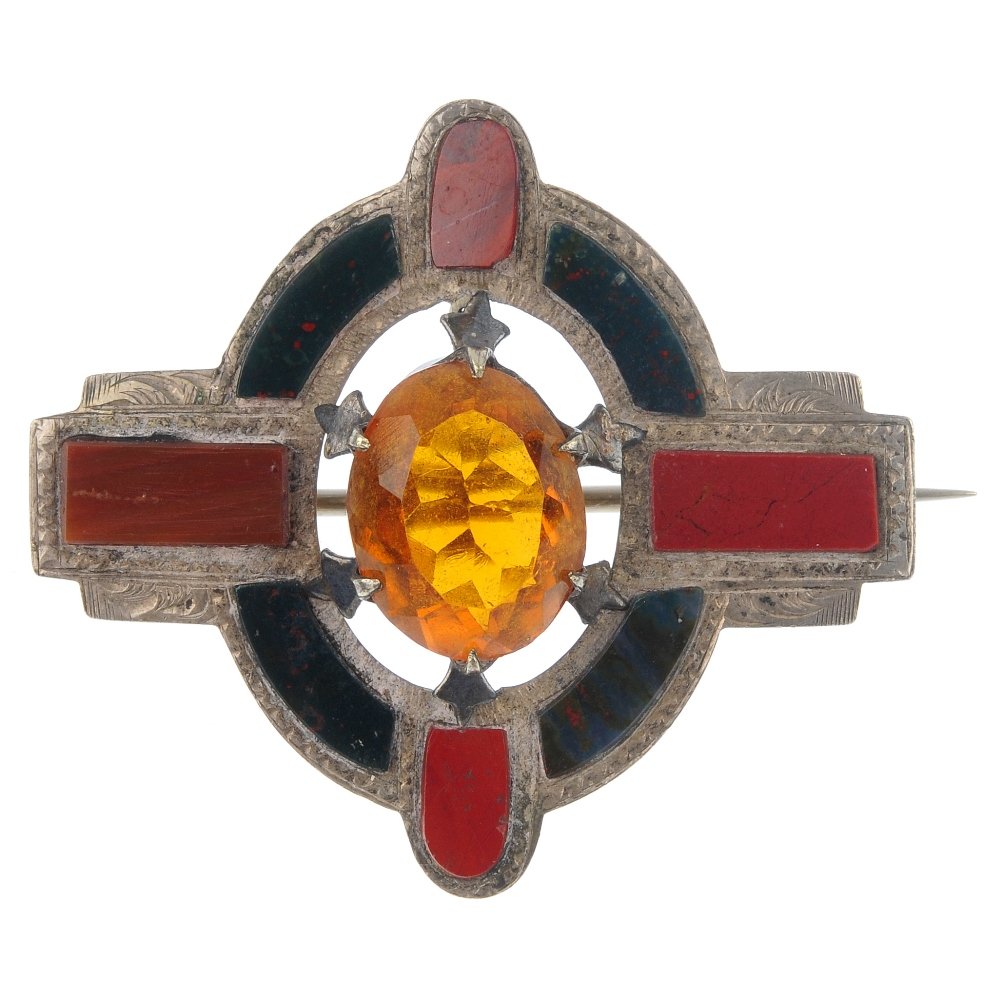 A Scottish paste and agate brooch.: A Scottish paste and agate brooch, the oval-shape orange paste, to the bloodstone oval-shape surround, with jasper panel accents. Length 4cms. Weight 8.3gms.