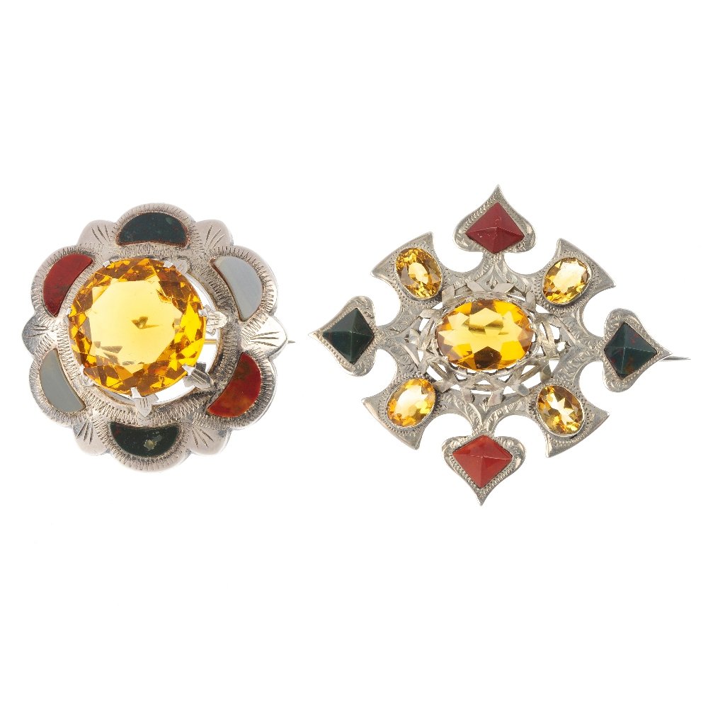 Two Scottish brooches.: Two Scottish brooches, the first set with a circular-shape orange paste, within a hardstone surround, the second set with an oval-shape orange paste, within a paste, citrine and hardstone surround. Le