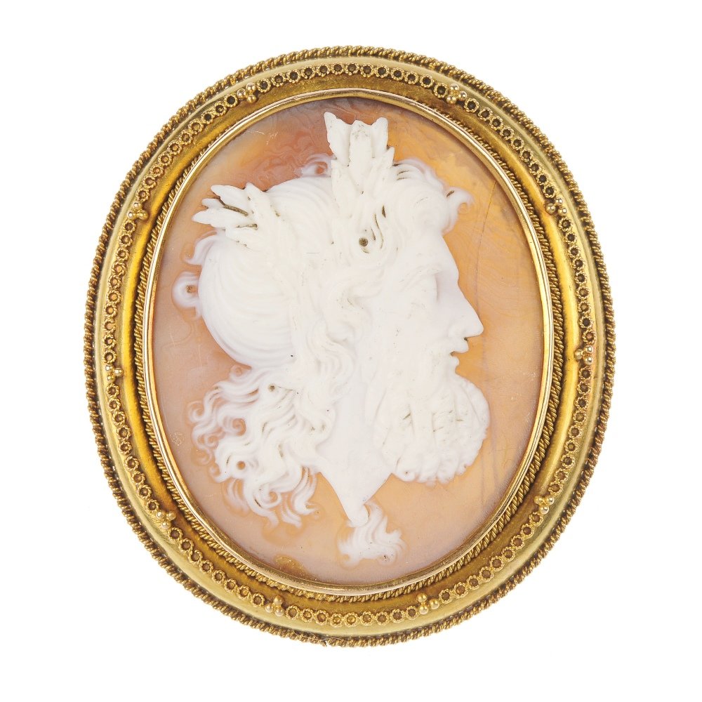 A late 19th century gold shell cameo brooch.: A late 19th century gold shell cameo brooch, of oval-shape outline, the shell cameo carved to depict the side profile of a bearded gentleman with wheat sheaves in his hair, within a rope-twist and fil