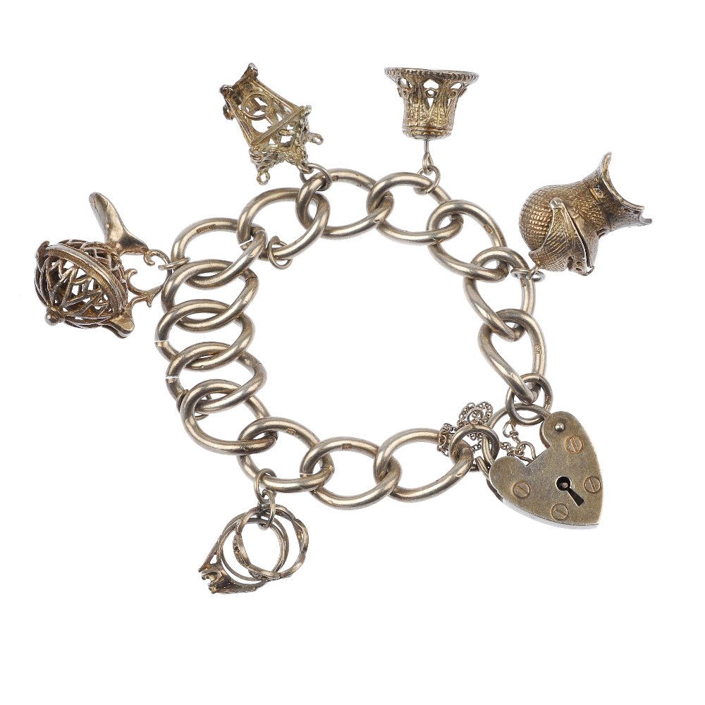 Three charm bracelets.: Three charm bracelets, each designed as a curb-link bracelet, suspending a series of charms to include a poodle, a bell and a cat. Two padlocks with hallmarks for Birmingham. Twelve pieces indicating
